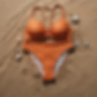 Stylish swimsuit bottoms arranged aesthetically on sand