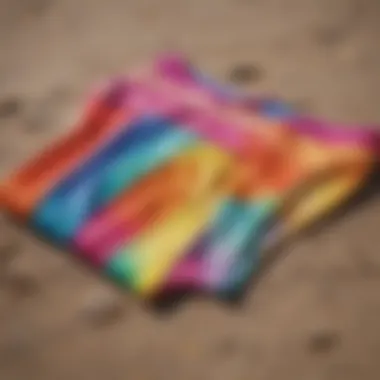 A variety of vibrant swimsuit bottoms displayed on a beach