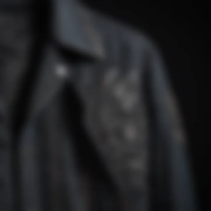 Close-up of intricate stitching details on the black denim jacket