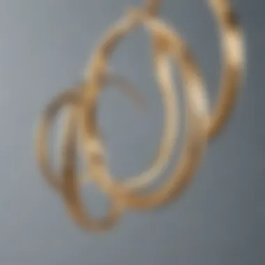 A close-up of various design variations of gold hoop earrings